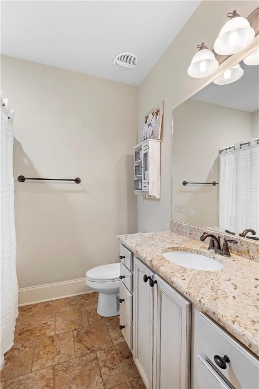 bathroom featuring vanity and toilet