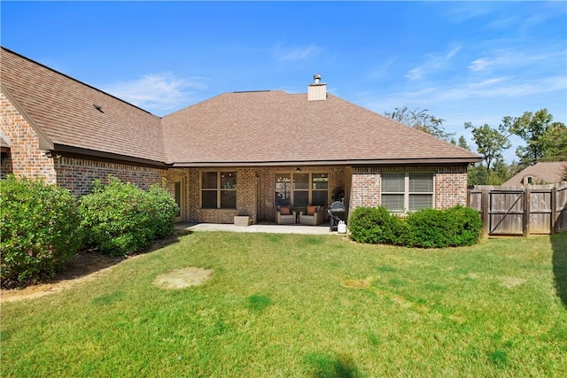 rear view of house featuring a yard and a patio area