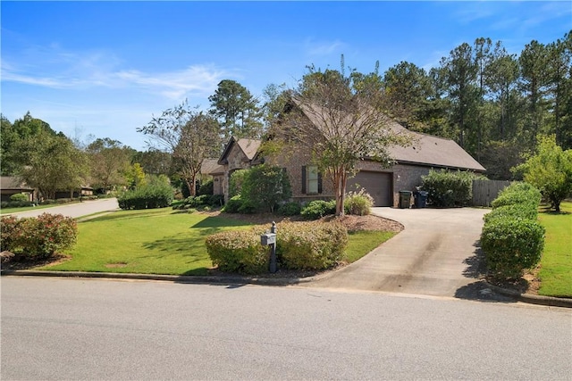 view of front of house with a garage and a front lawn