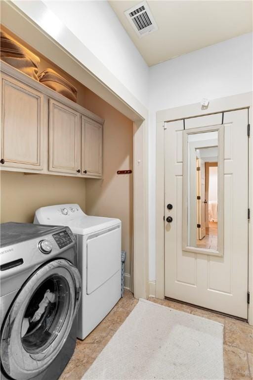 laundry room with cabinets and separate washer and dryer