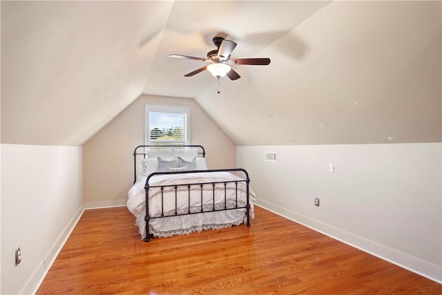 bedroom featuring vaulted ceiling, ceiling fan, and light wood-type flooring