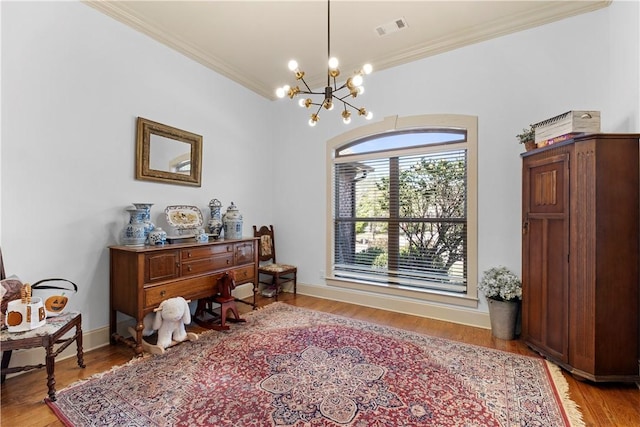 office area with an inviting chandelier, ornamental molding, and light hardwood / wood-style floors