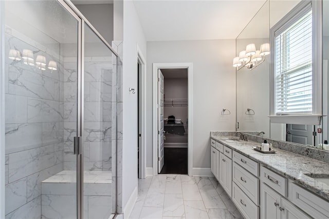 bathroom with vanity, an inviting chandelier, and walk in shower