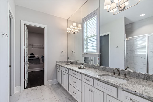 bathroom with walk in shower, vanity, and an inviting chandelier