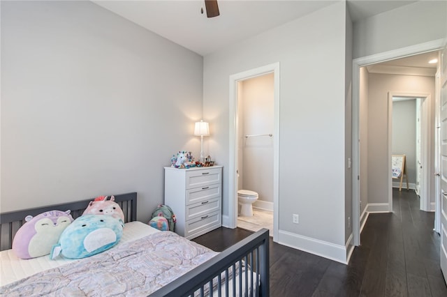 bedroom featuring dark hardwood / wood-style flooring, ensuite bathroom, and ceiling fan