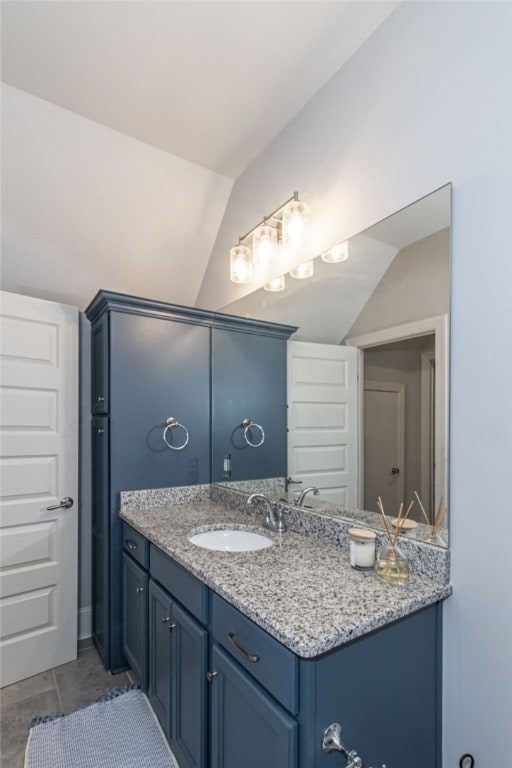 bathroom featuring vanity and vaulted ceiling