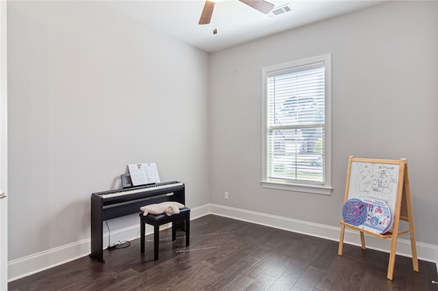 misc room featuring ceiling fan and dark wood-type flooring