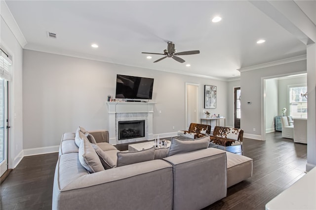 living room with dark hardwood / wood-style flooring, ceiling fan, and crown molding