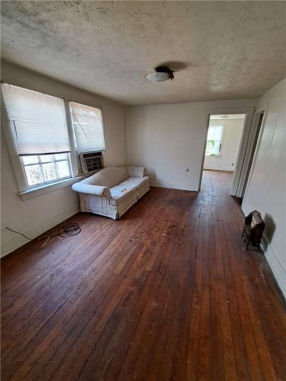 unfurnished bedroom with multiple windows, dark wood finished floors, and a textured ceiling