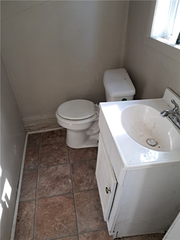 half bathroom with vanity and toilet