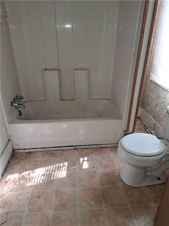 bathroom with bathtub / shower combination and toilet