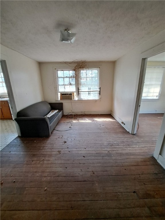 unfurnished room featuring a textured ceiling, cooling unit, and hardwood / wood-style flooring