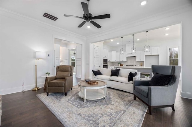 living room featuring crown molding, ceiling fan, and dark hardwood / wood-style flooring