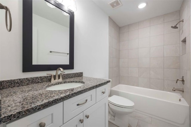 full bathroom with toilet, tiled shower / bath, and vanity