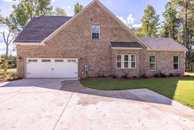 view of front of home featuring a garage and a front lawn