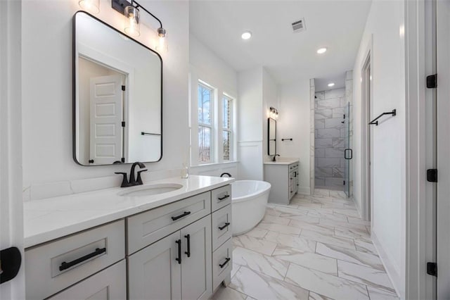 bathroom with vanity and shower with separate bathtub