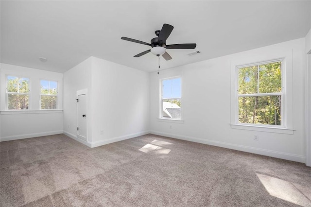 unfurnished room featuring light colored carpet and ceiling fan