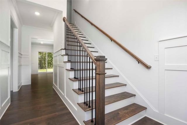 stairs with wood-type flooring and ornamental molding