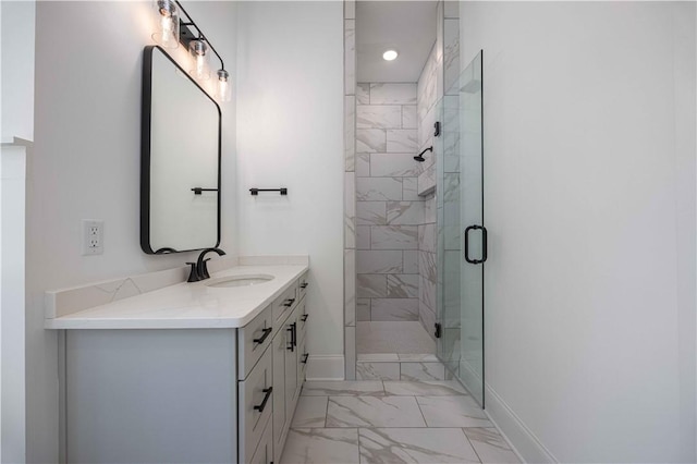 bathroom featuring walk in shower and vanity