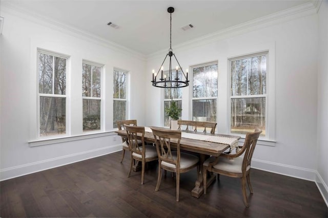 dining area featuring a chandelier, dark hardwood / wood-style floors, and ornamental molding