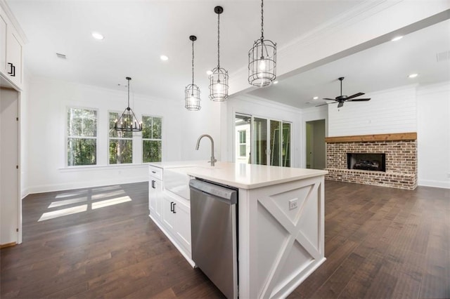 kitchen featuring white cabinetry, hanging light fixtures, a kitchen island with sink, and stainless steel dishwasher