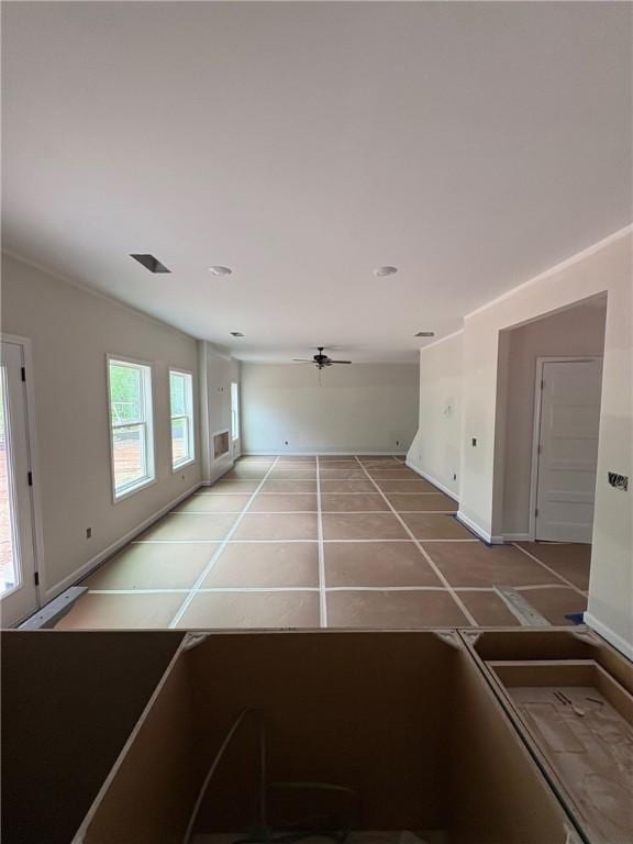 interior space featuring baseboards and light tile patterned flooring