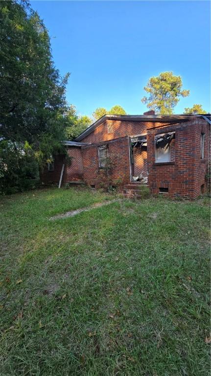 1270 Lee Road 57, Auburn, AL 36832 - rear view of house with a lawn and brick siding