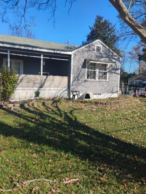 view of property exterior with a yard