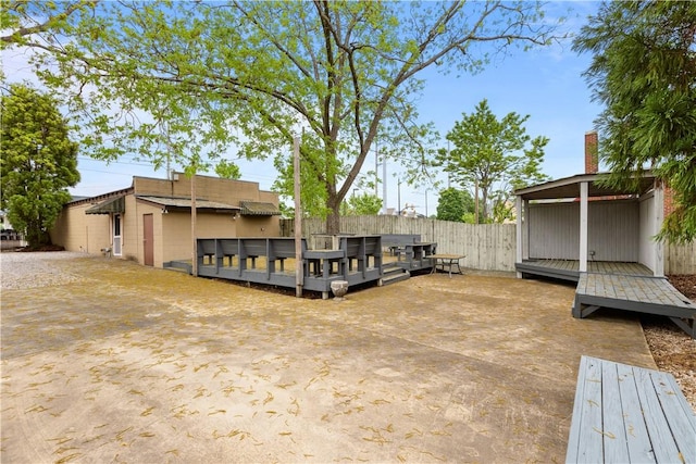 exterior space featuring a wooden deck and fence