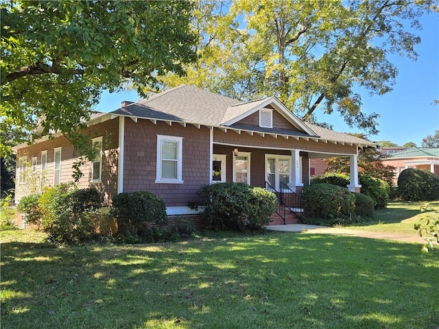 view of front facade with covered porch and a front lawn