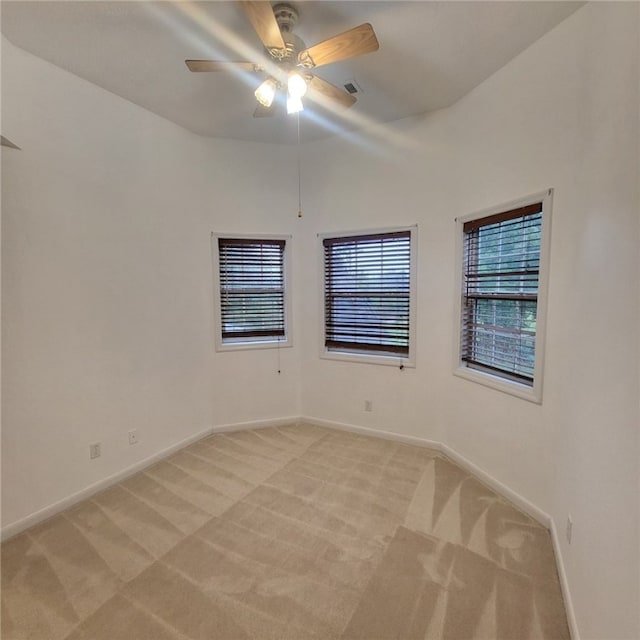 carpeted spare room with ceiling fan