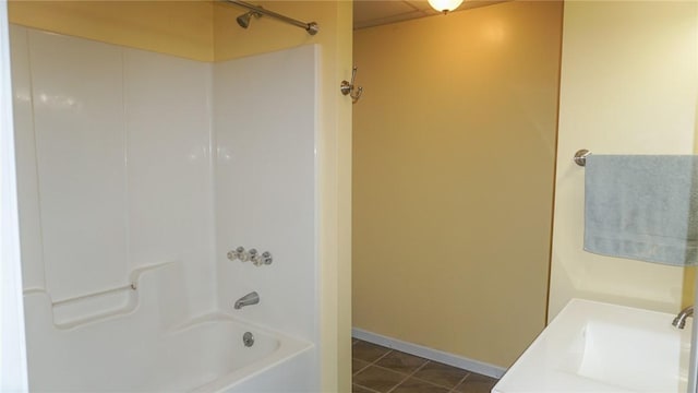 bathroom with bathtub / shower combination, tile patterned floors, and sink