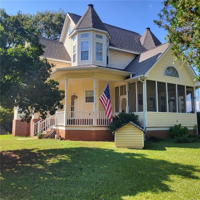 victorian home with covered porch and a front lawn