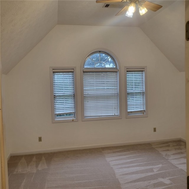 bonus room featuring ceiling fan, light colored carpet, a textured ceiling, and vaulted ceiling