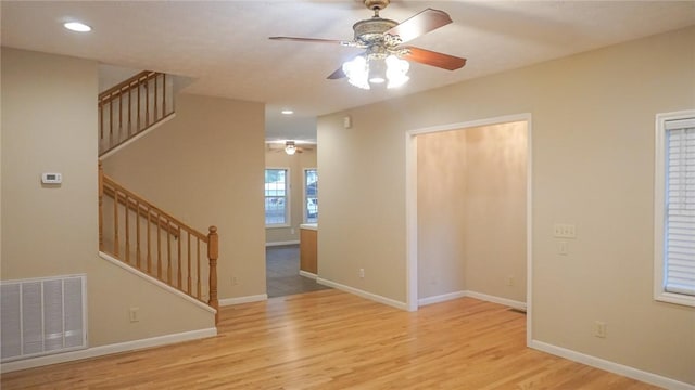 unfurnished room with ceiling fan and light hardwood / wood-style floors