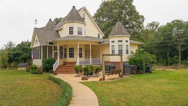 back of property featuring a patio area and a yard