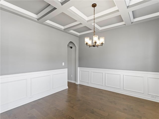 unfurnished room with arched walkways, beam ceiling, a chandelier, and dark wood-style flooring