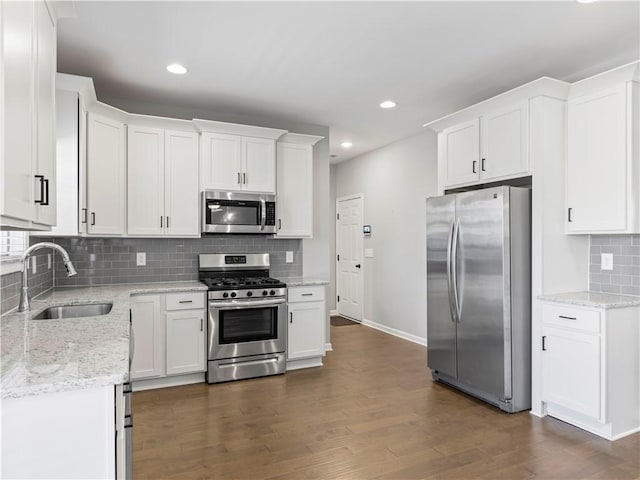 kitchen featuring a sink, appliances with stainless steel finishes, dark wood-style floors, and white cabinets