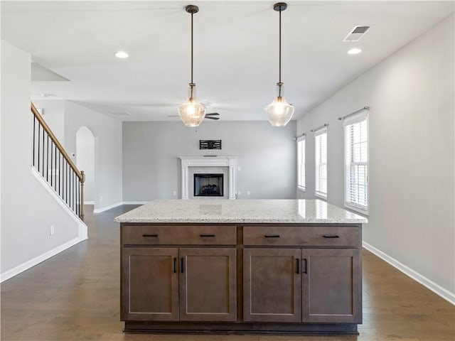 kitchen featuring open floor plan, baseboards, visible vents, and dark wood-style flooring