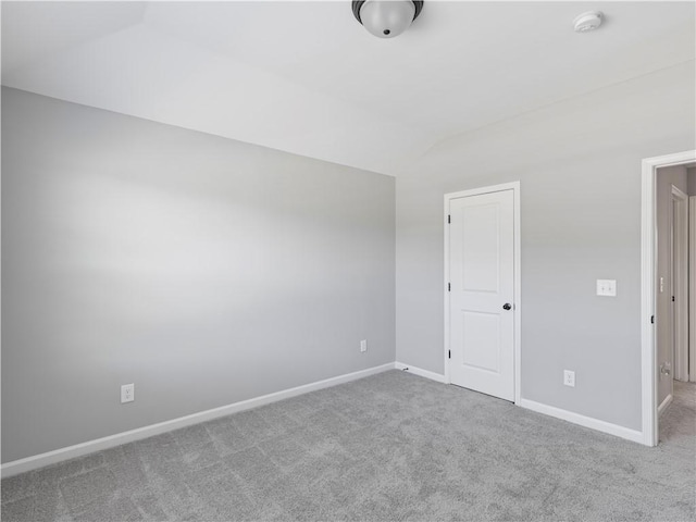 interior space with lofted ceiling and baseboards