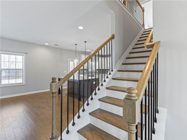 stairs featuring visible vents, recessed lighting, wood finished floors, and baseboards