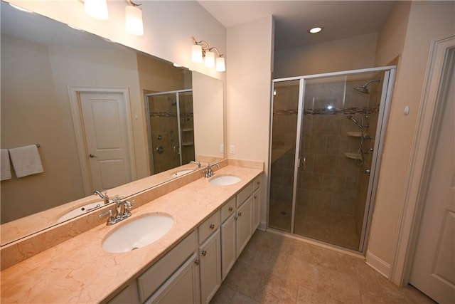full bathroom featuring double vanity, a sink, and a stall shower