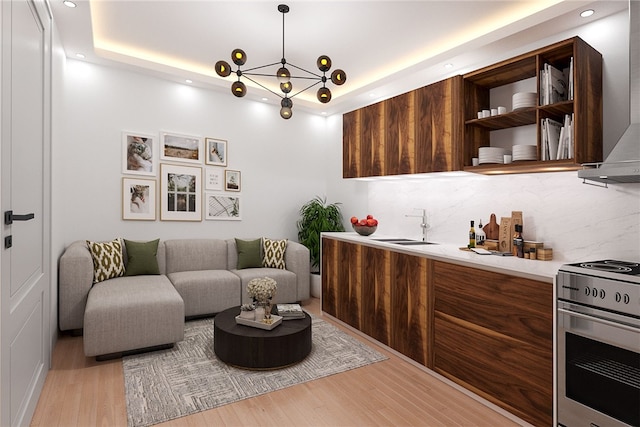 interior space featuring sink, light hardwood / wood-style flooring, and a tray ceiling