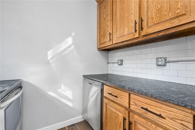 kitchen with dishwasher, stove, backsplash, and dark stone counters