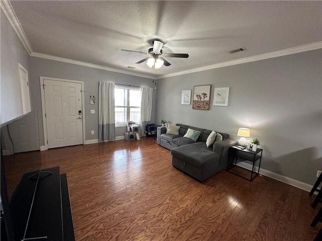 living area with baseboards, crown molding, ceiling fan, and wood finished floors