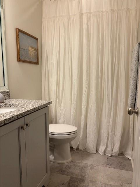 bathroom featuring toilet and vanity