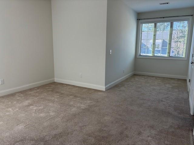 spare room featuring carpet floors