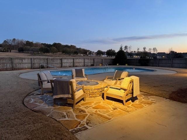 pool at dusk with a patio