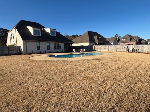 exterior space with a fenced in pool