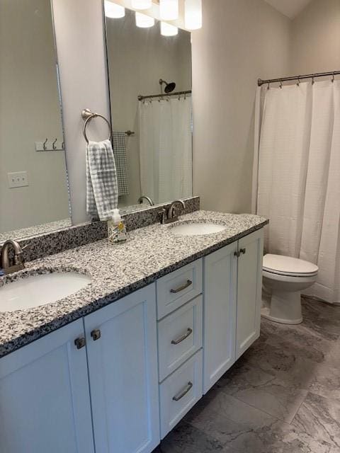 bathroom featuring toilet and vanity